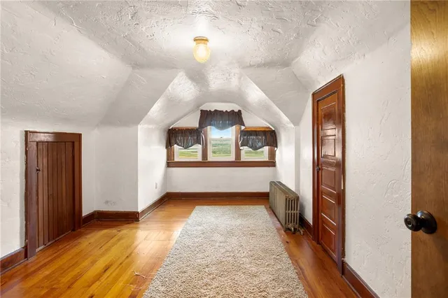 a view of a room with wooden floor and furniture