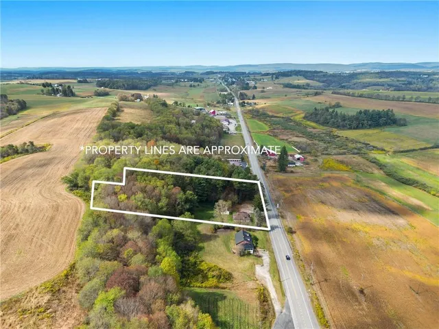 an aerial view of beach and residential houses with outdoor space