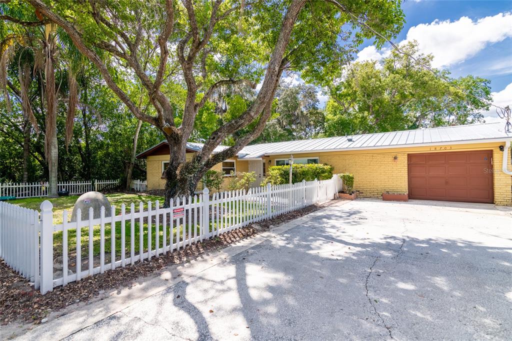 18703 Yocam Avenue Lutz, FL 33549 - Photo 1 of 27 a view of a garden with wooden fence