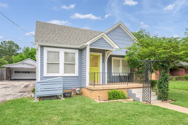 a front view of a house with a yard and porch