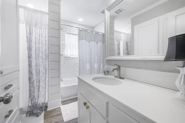 a bathroom with a granite countertop sink a toilet and shower
