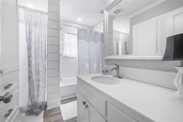 a bathroom with a granite countertop sink a toilet and shower