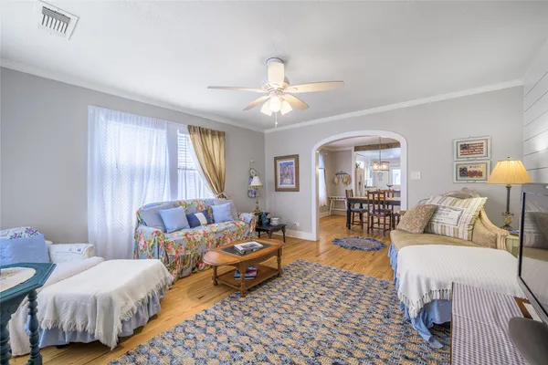 a living room with furniture and a chandelier