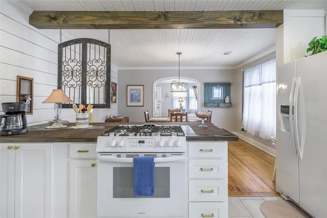 a kitchen with stainless steel appliances granite countertop a stove and cabinets