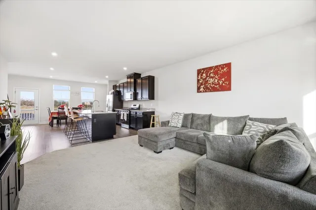 a living room with furniture kitchen view and a table