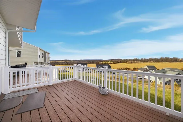a view of a balcony with wooden floor and city view