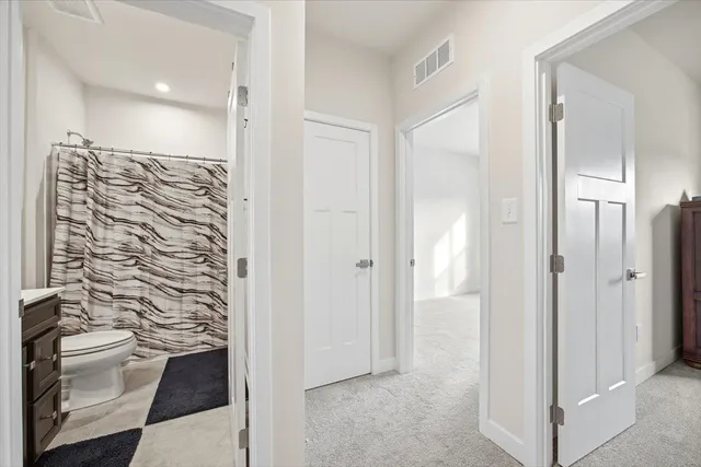 a bathroom with a shower and a toilet