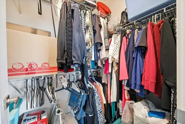 a view of walk in closet with clothes
