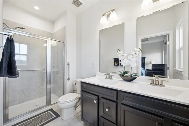 a bathroom with a sink a toilet and shower