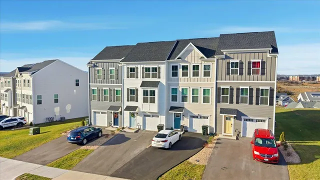 a front view of a residential apartment building with a yard