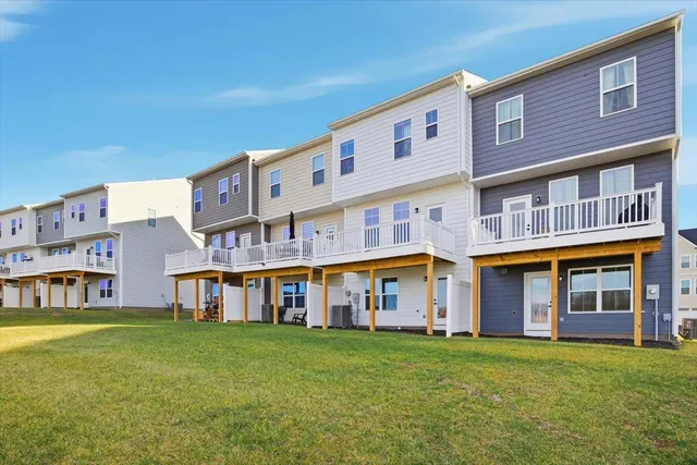 a view of an apartment with a garden and deck