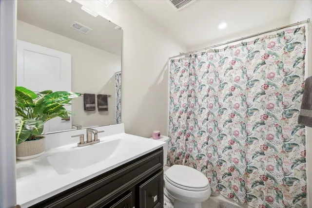 a bathroom with a sink toilet and mirror