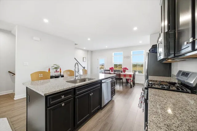 a kitchen with a table chairs stove and cabinets