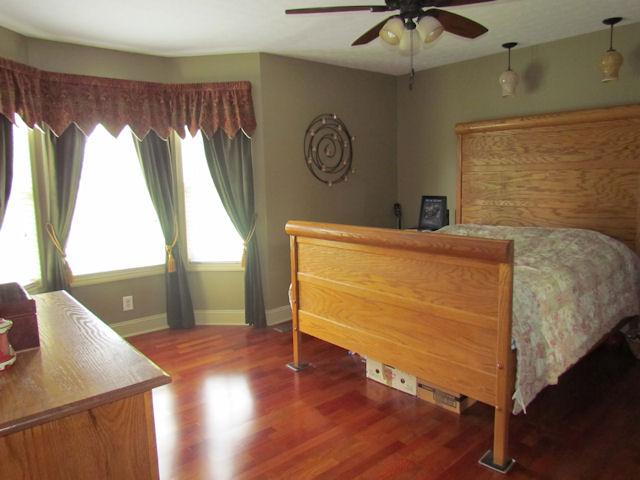 471 Old Hunters Point Pike North Lebanon, TN 37087 - Photo 3 of 16 Master bedroom includes hardwood flooring, a ceiling fan, crown moulding, reading lights over the bed, a bay window and a walk in closet.