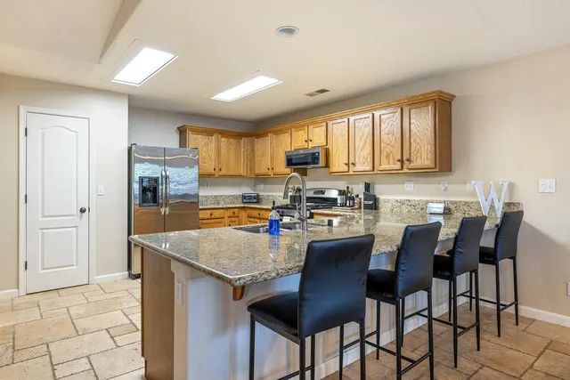 a kitchen with a table chairs refrigerator and cabinets