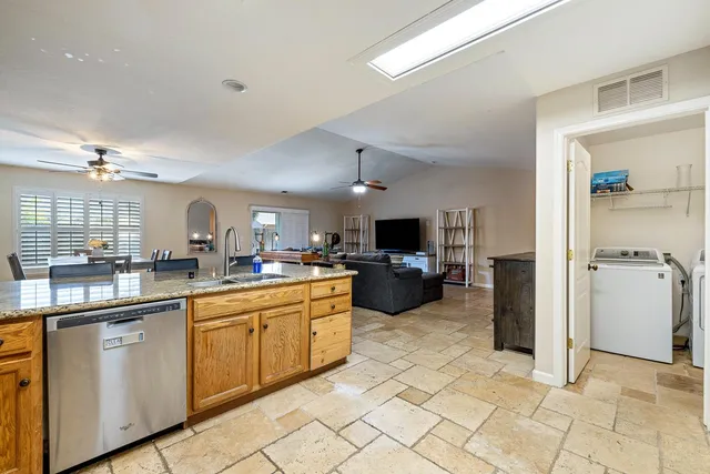 a large kitchen with cabinets and chairs