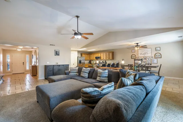 a living room with furniture and a chandelier