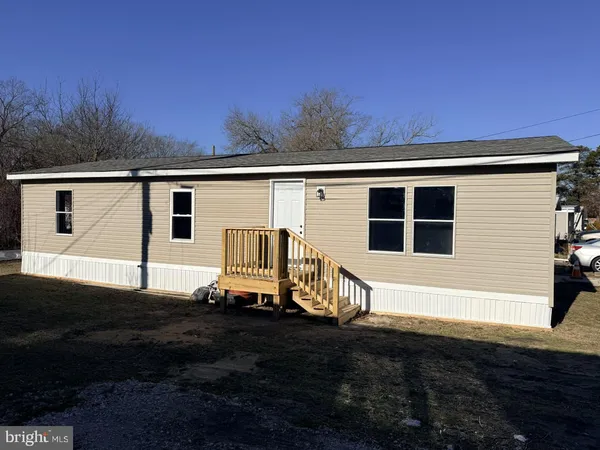 a view of backyard with barbeque grill and wooden fence