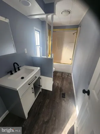 a view of washer and dryer with wooden floor