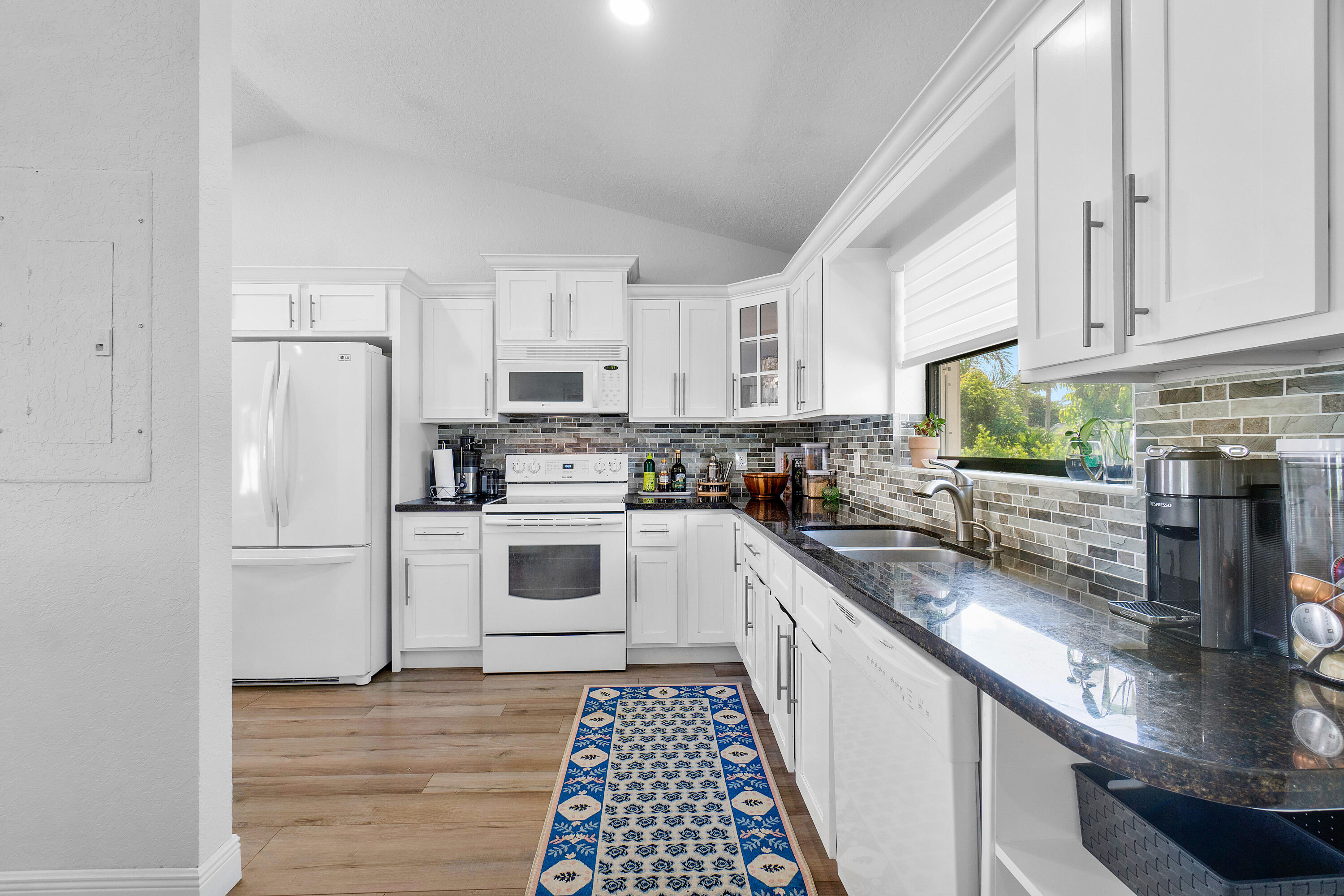 6085 Robinson Street Jupiter, FL 33458 - Photo 11 of 32 a kitchen with stainless steel appliances granite countertop a stove a sink dishwasher and a refrigerator