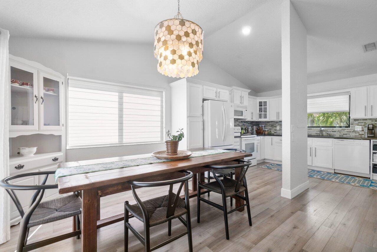 6085 Robinson Street Jupiter, FL 33458 - Photo 14 of 32 a view of a dining room with furniture window and wooden floor