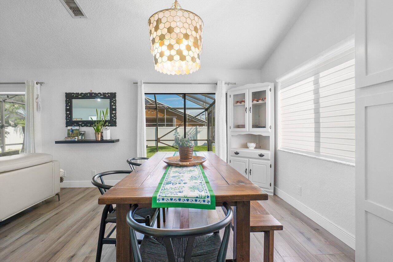 6085 Robinson Street Jupiter, FL 33458 - Photo 15 of 32 a view of a dining room with furniture window and wooden floor