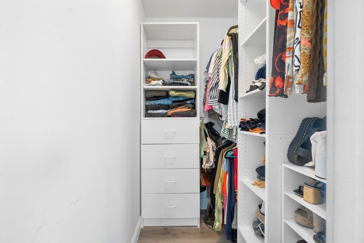 6085 Robinson Street Jupiter, FL 33458 - Photo 18 of 32 a view of walk in closet with clothes and shoes