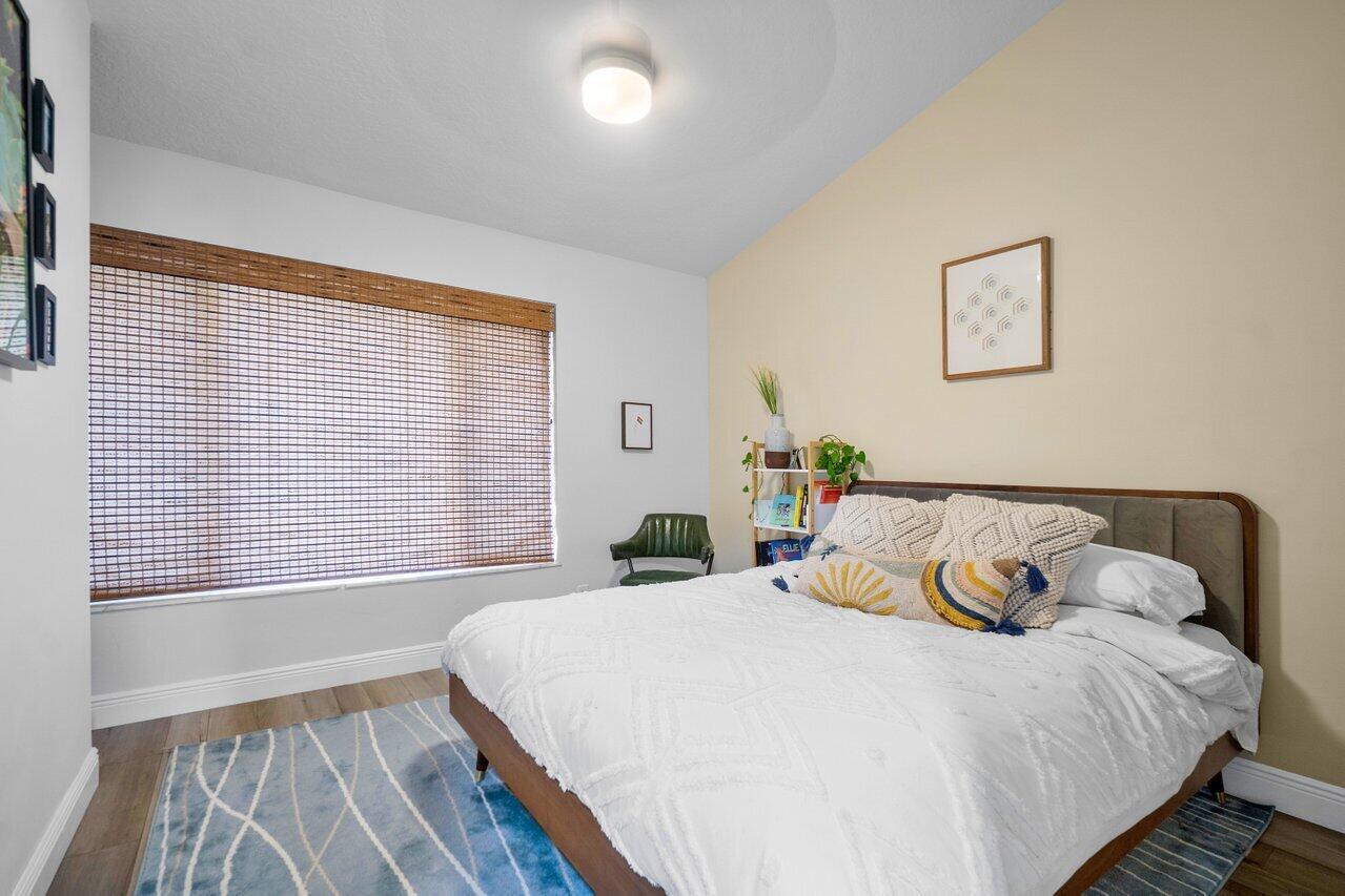6085 Robinson Street Jupiter, FL 33458 - Photo 20 of 32 a bedroom with a bed and a large window