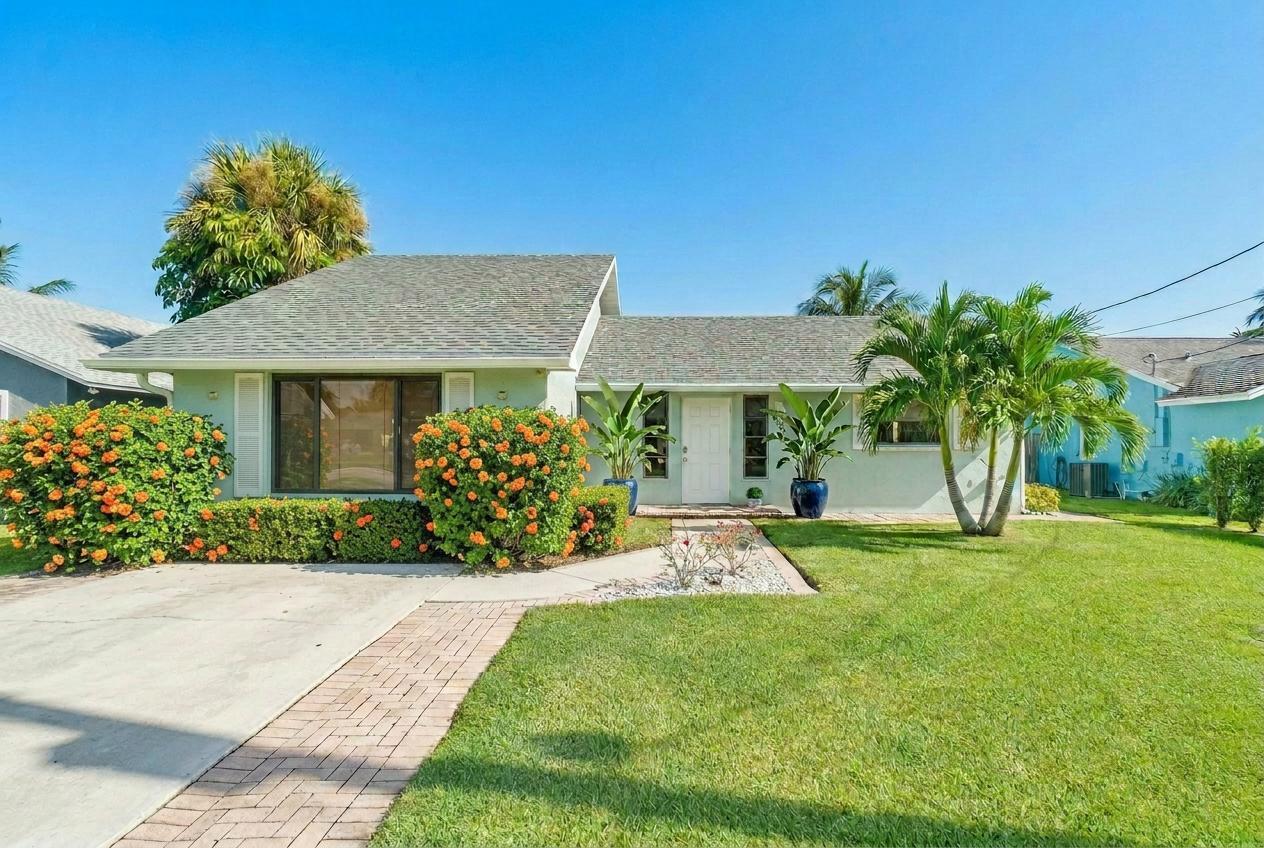 6085 Robinson Street Jupiter, FL 33458 - Photo 2 of 32 a view of a house with a yard