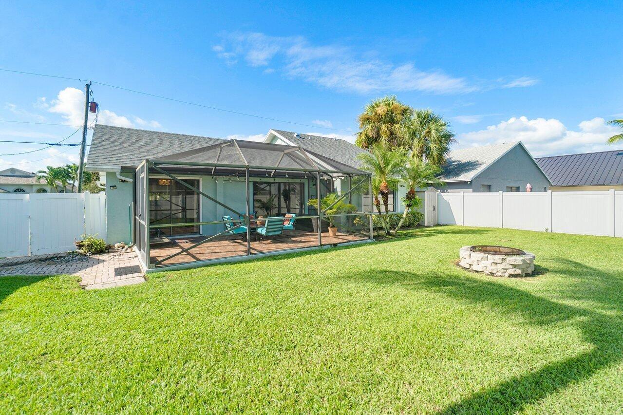 6085 Robinson Street Jupiter, FL 33458 - Photo 23 of 32 a view of a house with backyard porch and sitting area