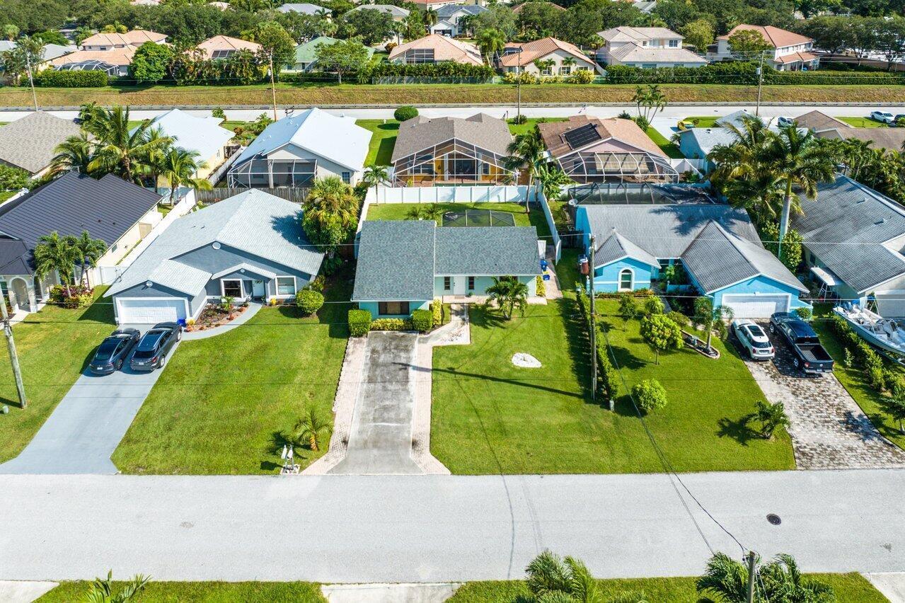 6085 Robinson Street Jupiter, FL 33458 - Photo 24 of 32 an aerial view of residential houses with outdoor space and lake view