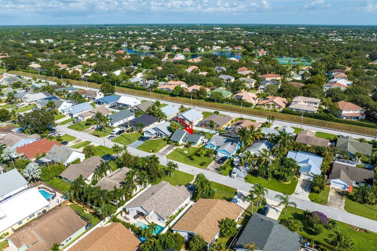 6085 Robinson Street Jupiter, FL 33458 - Photo 25 of 32 an aerial view of residential houses with outdoor space and trees