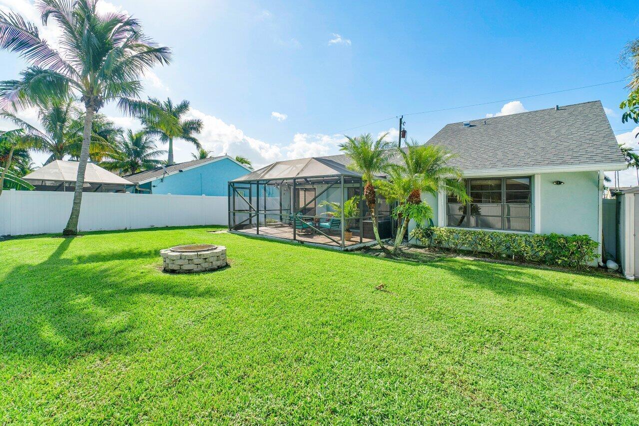 6085 Robinson Street Jupiter, FL 33458 - Photo 7 of 32 a view of a backyard with a garden and plants