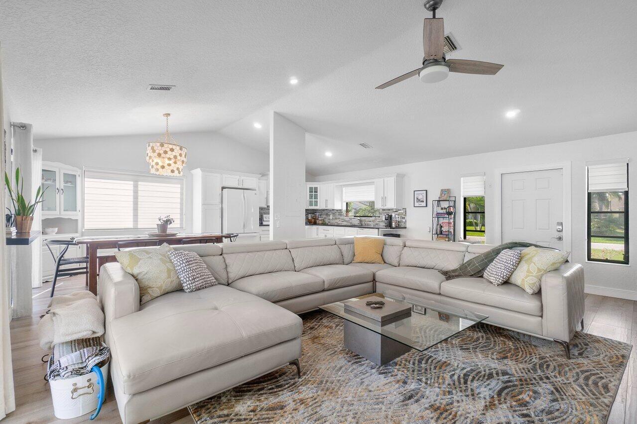 6085 Robinson Street Jupiter, FL 33458 - Photo 9 of 32 a living room with furniture and a large window