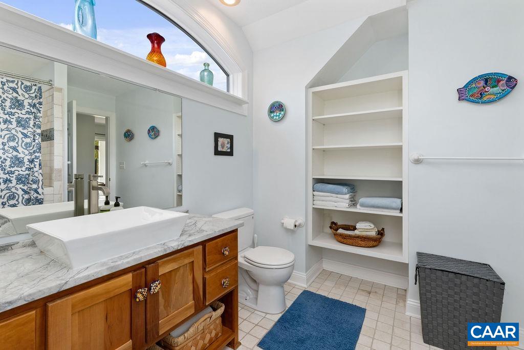 132 Reeds Gap Road Lyndhurst, VA 22952 - Photo 45 of 74 a spacious bathroom with a granite countertop sink a toilet and a mirror