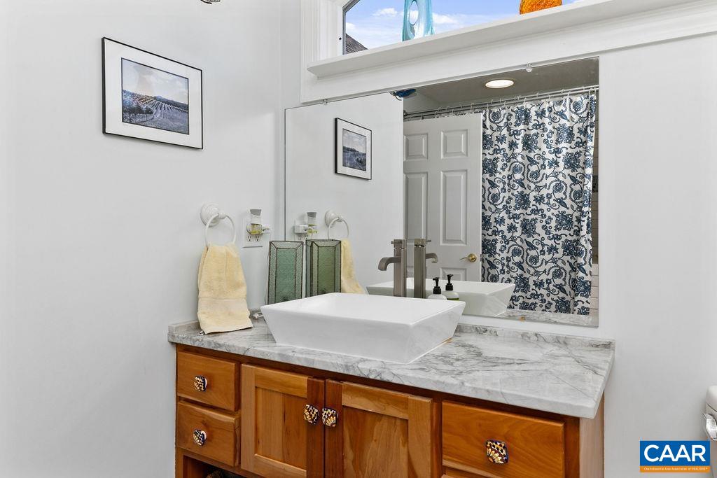 132 Reeds Gap Road Lyndhurst, VA 22952 - Photo 46 of 74 a bathroom with a granite countertop sink and a mirror