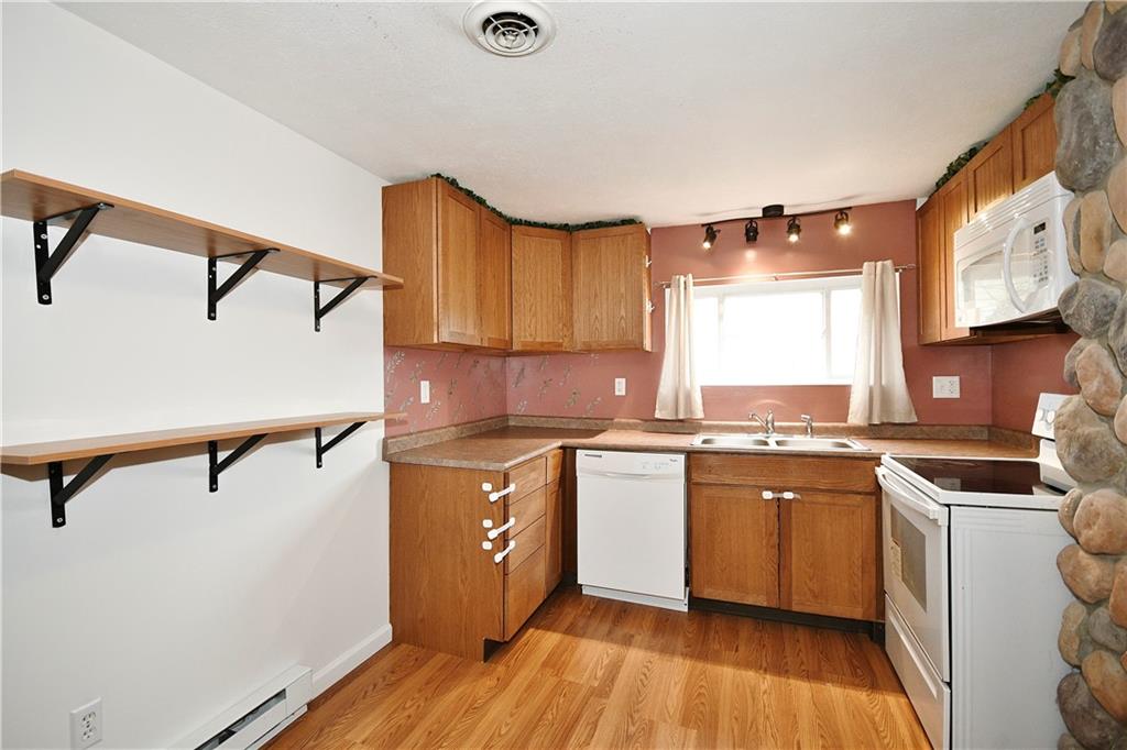 66 Chestnut Street Ellsworth, PA 15331 - Photo 12 of 28 a kitchen with stainless steel appliances granite countertop a sink a stove and refrigerator