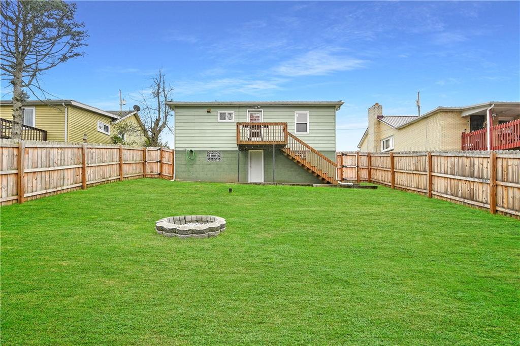 66 Chestnut Street Ellsworth, PA 15331 - Photo 2 of 28 a view of a backyard with a garden and deck