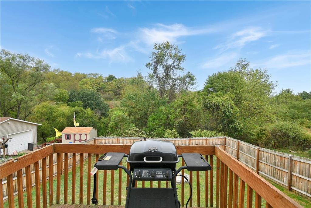 66 Chestnut Street Ellsworth, PA 15331 - Photo 24 of 28 a view of a roof deck with table and chairs with wooden floor and fence