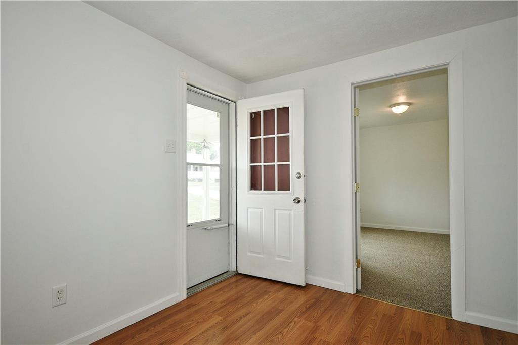 66 Chestnut Street Ellsworth, PA 15331 - Photo 5 of 28 an empty room with wooden floor and windows