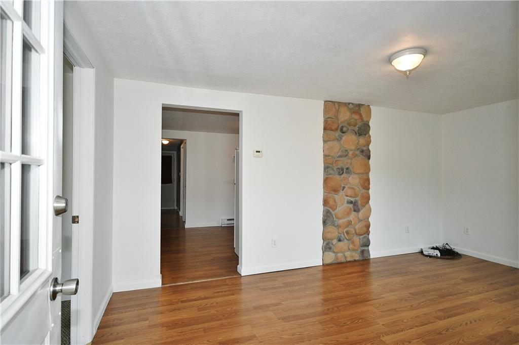 66 Chestnut Street Ellsworth, PA 15331 - Photo 6 of 28 an empty room with wooden floor and closet