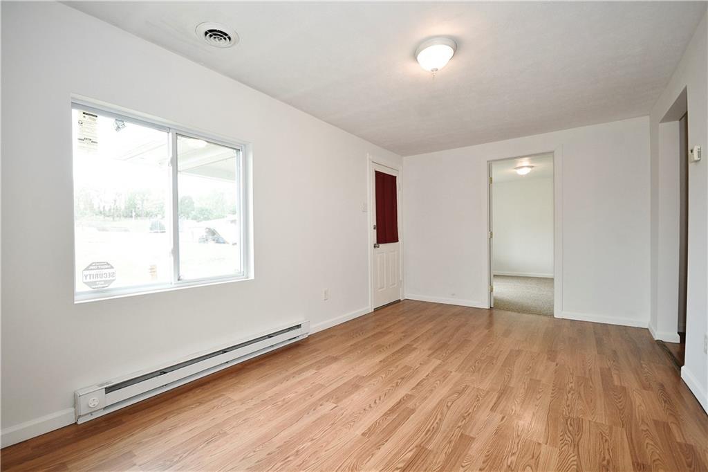 66 Chestnut Street Ellsworth, PA 15331 - Photo 9 of 28 a view of an empty room with wooden floor and a window