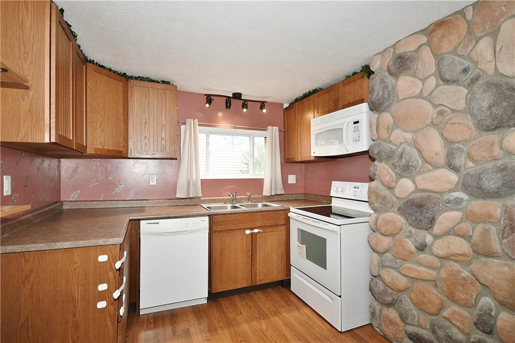 66 Chestnut Street Ellsworth, PA 15331 - Photo 10 of 28 a kitchen with stainless steel appliances a stove a sink and a microwave