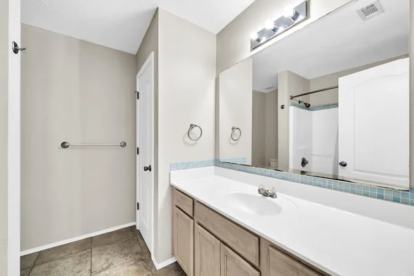 a bathroom with a shower curtain and a window