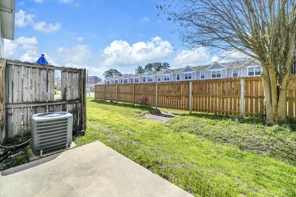 a view of a backyard with wooden fence