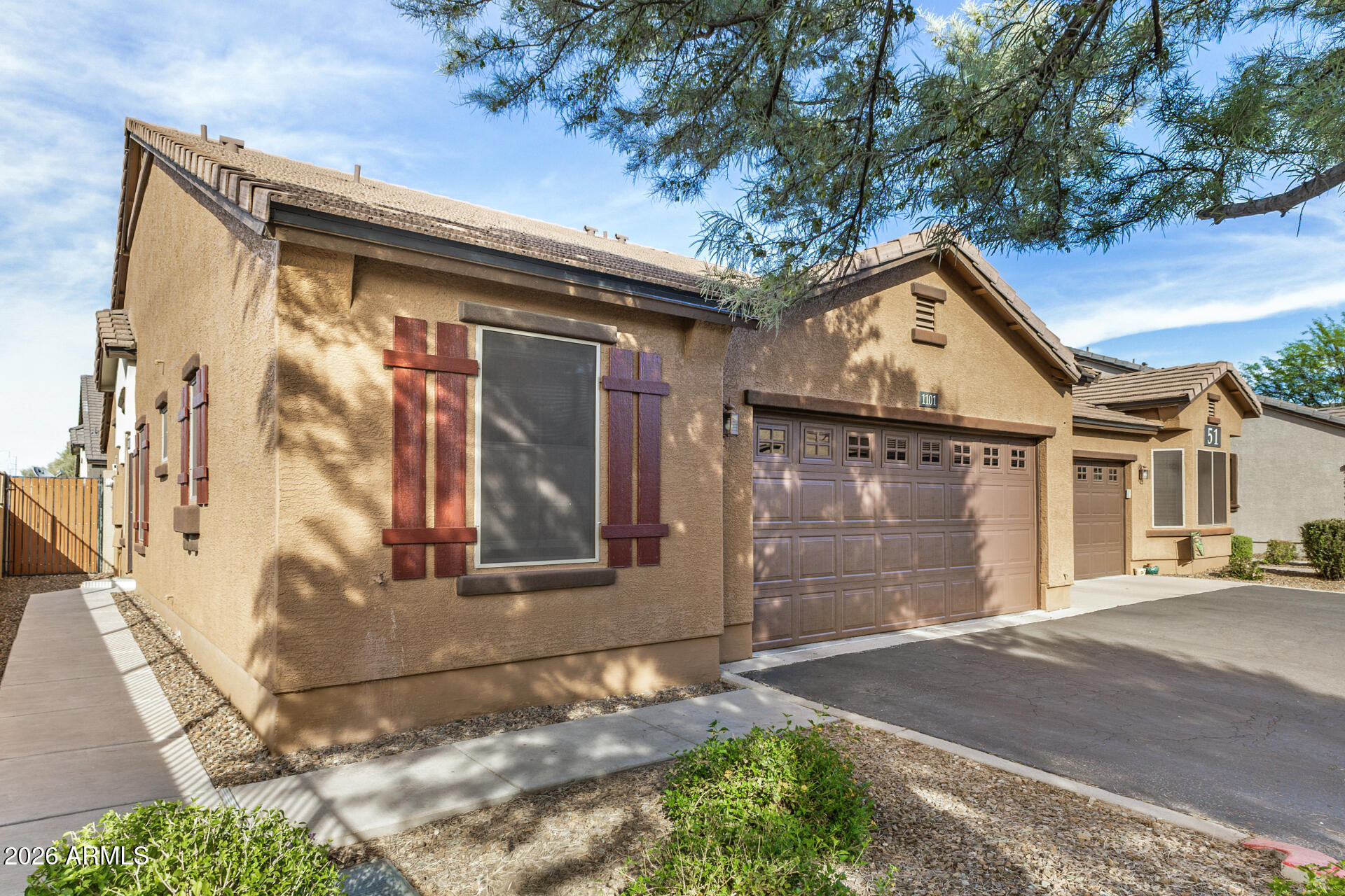 2725 East Mine Creek Road, Unit 1101 Phoenix, AZ 85024 - Photo 4 of 43 a front view of a house with a yard and garage