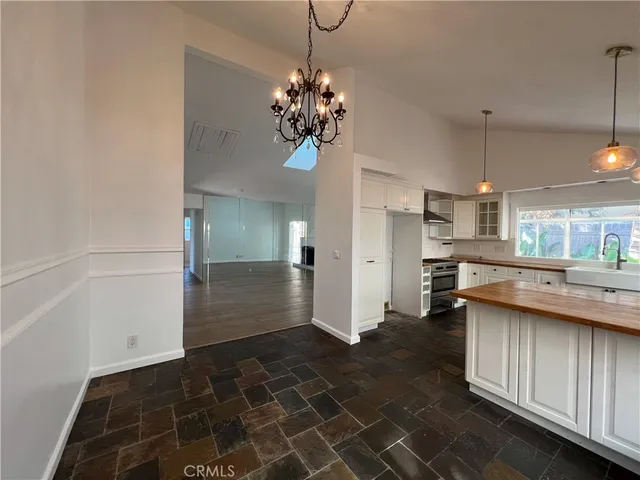 a kitchen with stainless steel appliances a refrigerator and microwave