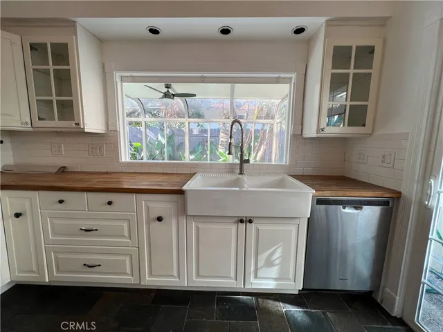 a kitchen with stainless steel appliances a sink and a window