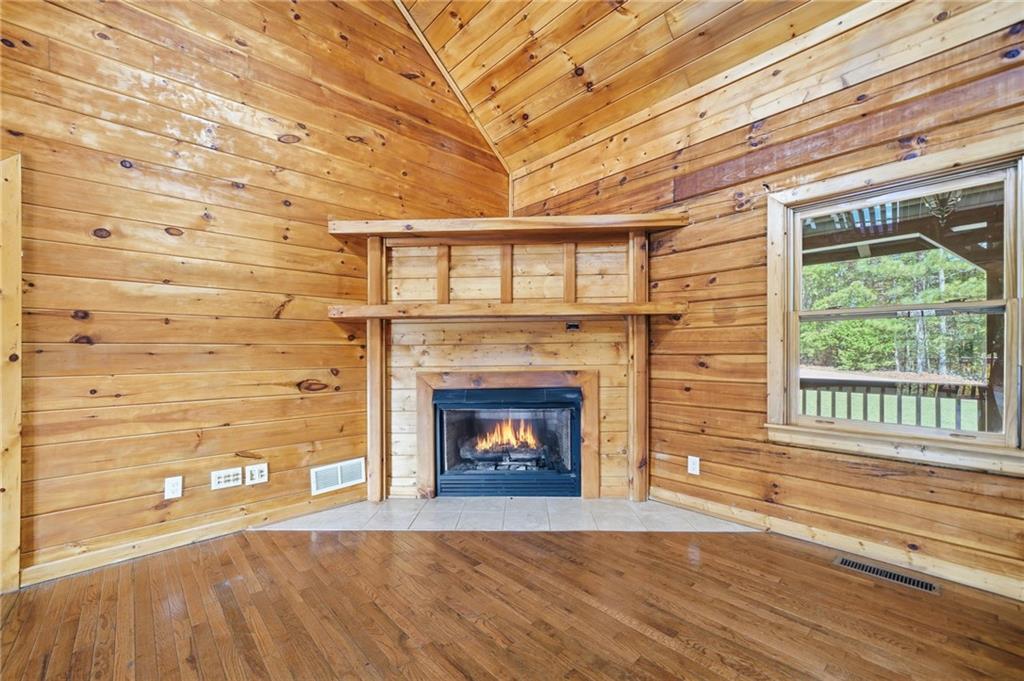 1384 Crystal Lane Northeast Ranger, GA 30734 - Photo 14 of 53 a living room with a fireplace in front of a window