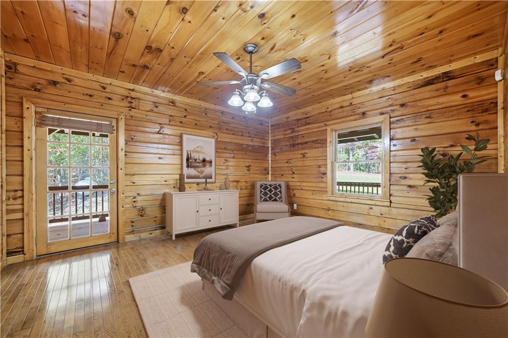 1384 Crystal Lane Northeast Ranger, GA 30734 - Photo 17 of 53 a bedroom with a large bed and wooden floor